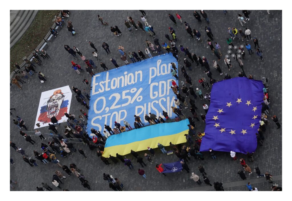 Estonian plan for Ukraine - picture of flash mob in Prague with large flags, russian monster and Estonian plan banner.